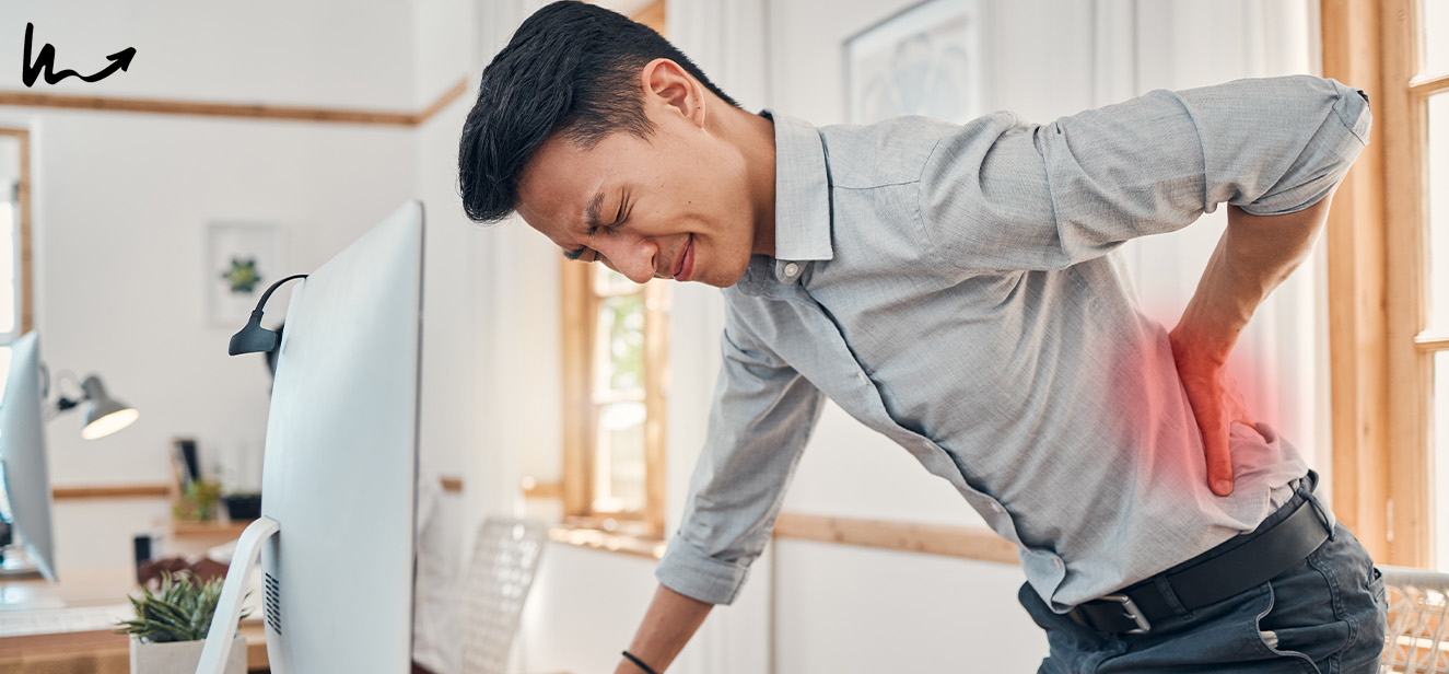 man touching his lower back in pain